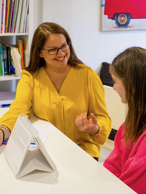 Sim reading with a student during a one-to-one session