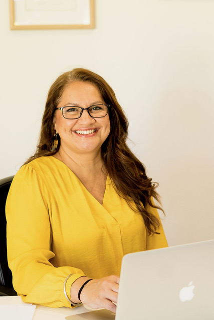 Sim Dhaliwal, speech pathologist and educator, at her desk